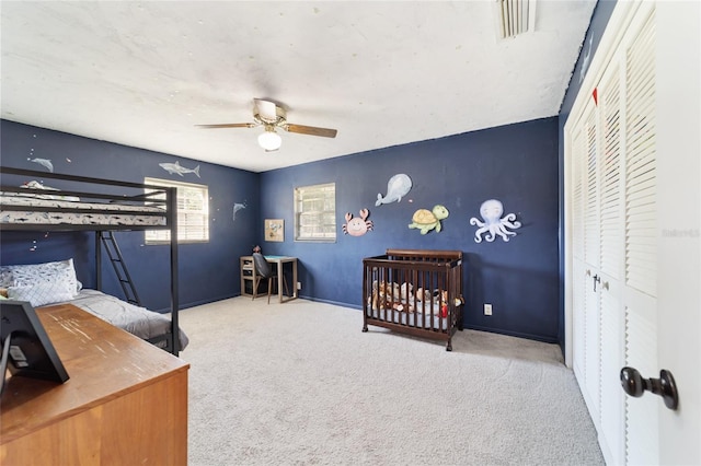 carpeted bedroom with a closet and ceiling fan