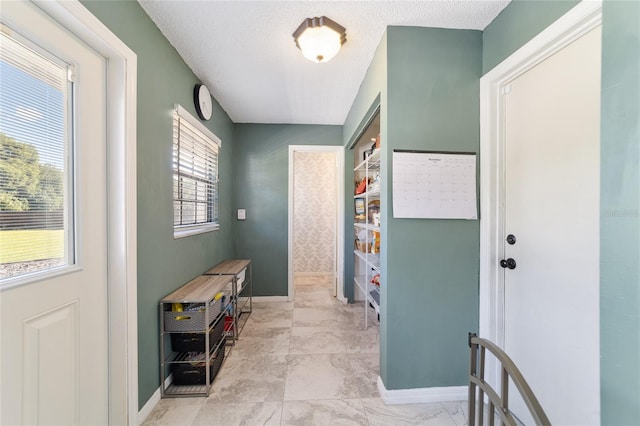 interior space featuring a textured ceiling and a healthy amount of sunlight