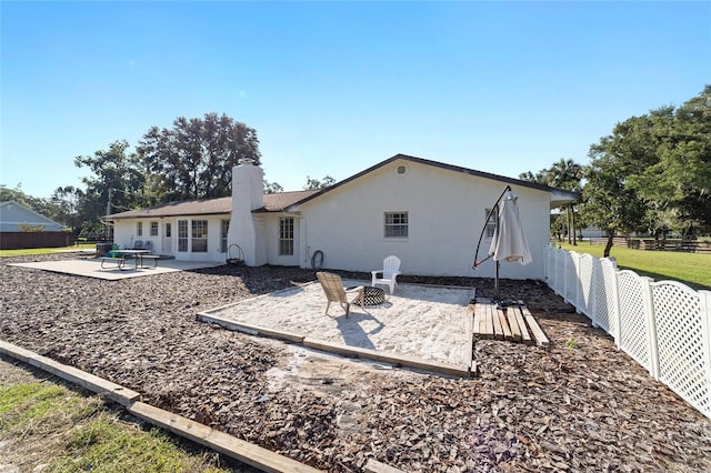 back of house with a patio