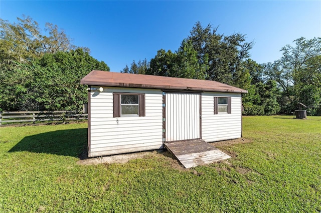 view of outbuilding with a yard