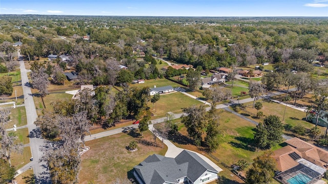 drone / aerial view featuring a residential view and a view of trees