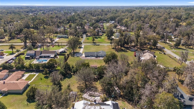 bird's eye view featuring a forest view and a residential view