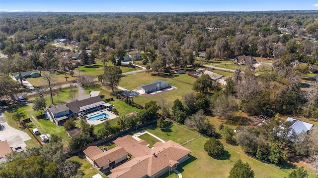 drone / aerial view featuring a residential view and a view of trees