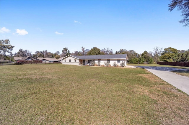 single story home with a front lawn and fence