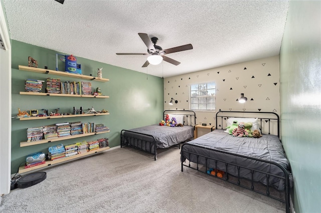 bedroom with carpet floors, ceiling fan, and a textured ceiling