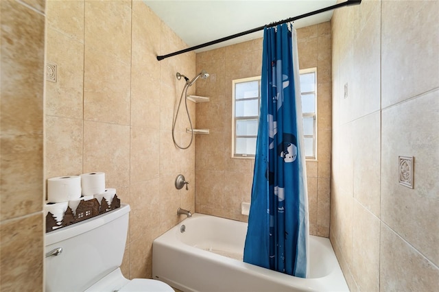 bathroom with shower / bath combination with curtain, toilet, and tile walls