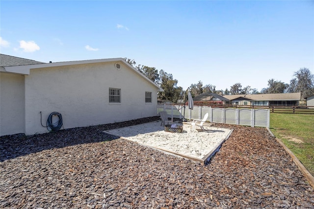 view of yard with an outdoor fire pit and fence