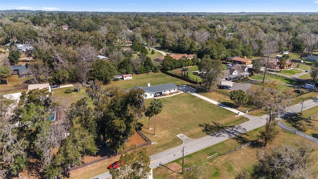 birds eye view of property featuring a wooded view