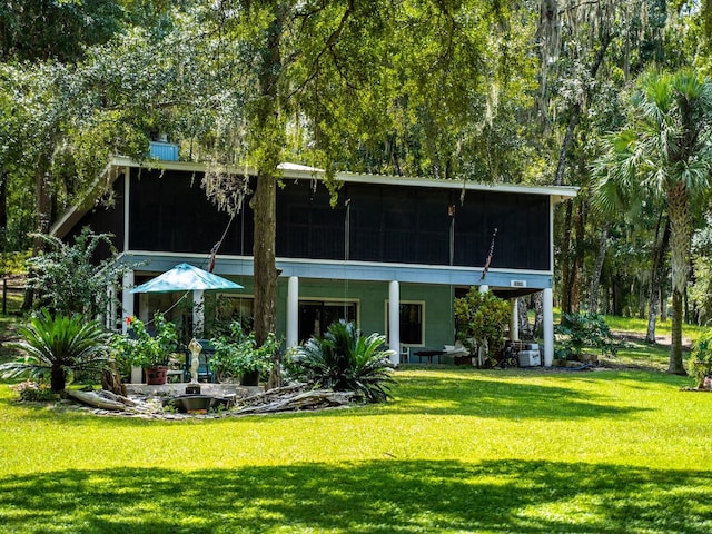 24750 NE 177th Ter, Fort Mc Coy, FL 32134 - rear view of house with a sunroom and a yard