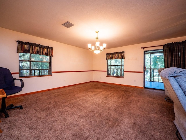 interior space featuring a textured ceiling and a chandelier