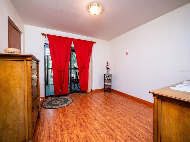 entrance foyer featuring a textured ceiling and hardwood / wood-style floors