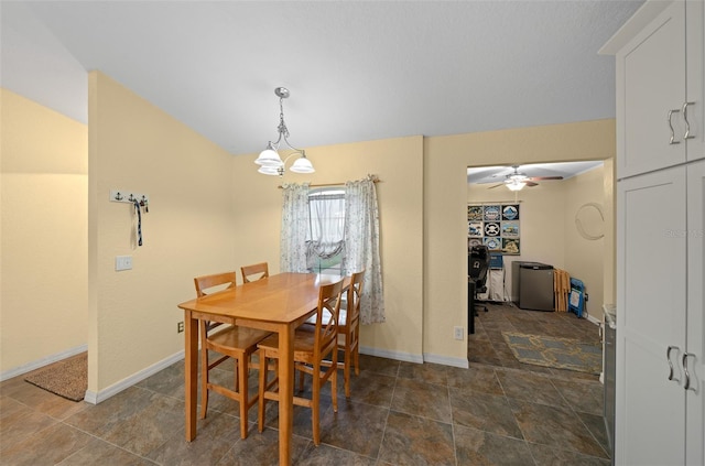 dining area featuring ceiling fan with notable chandelier