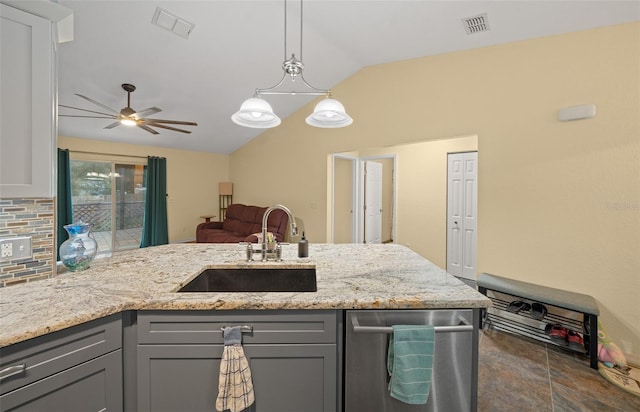 kitchen with lofted ceiling, sink, gray cabinetry, dishwasher, and light stone countertops