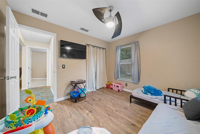 bedroom with light hardwood / wood-style floors and ceiling fan