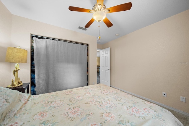 carpeted bedroom with ceiling fan and a closet