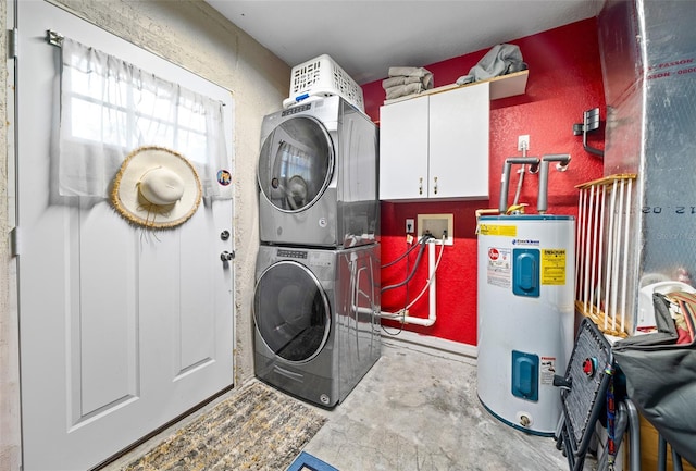 laundry area with water heater, stacked washer and clothes dryer, and cabinets