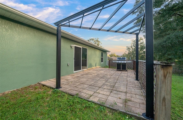 patio terrace at dusk with a pergola and a jacuzzi