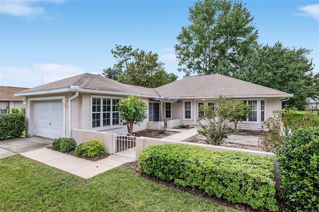 ranch-style home featuring a front yard and a garage