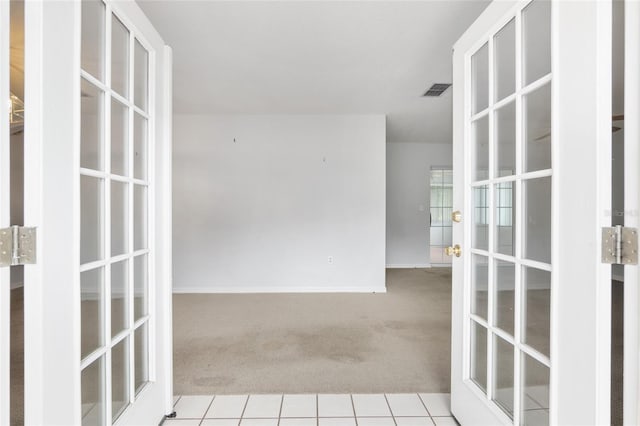 carpeted spare room with french doors