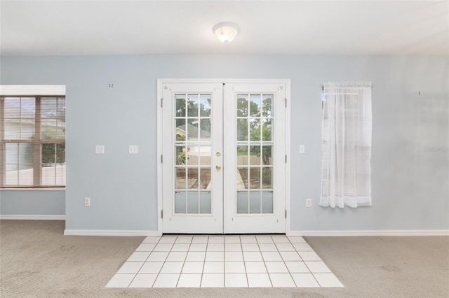 doorway with light carpet, french doors, and a healthy amount of sunlight