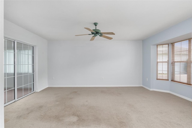 carpeted empty room featuring ceiling fan