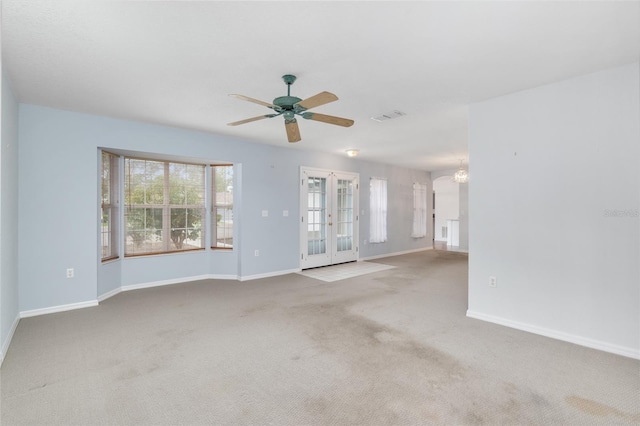 empty room featuring ceiling fan, french doors, and carpet flooring