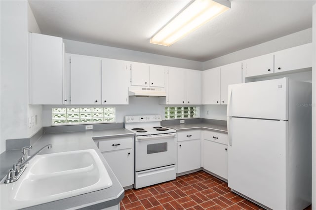 kitchen featuring white appliances, sink, and white cabinetry