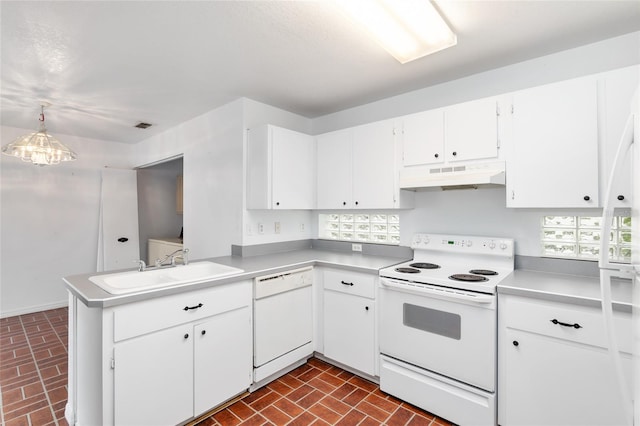 kitchen with pendant lighting, white appliances, sink, kitchen peninsula, and white cabinets