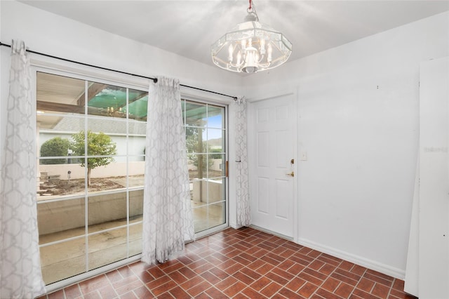 entryway with an inviting chandelier and a healthy amount of sunlight