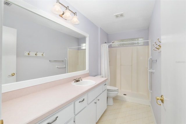 bathroom with curtained shower, vanity, and toilet