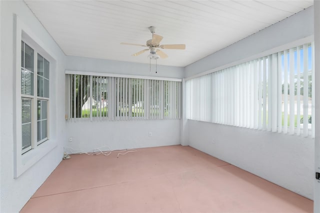 unfurnished sunroom with ceiling fan