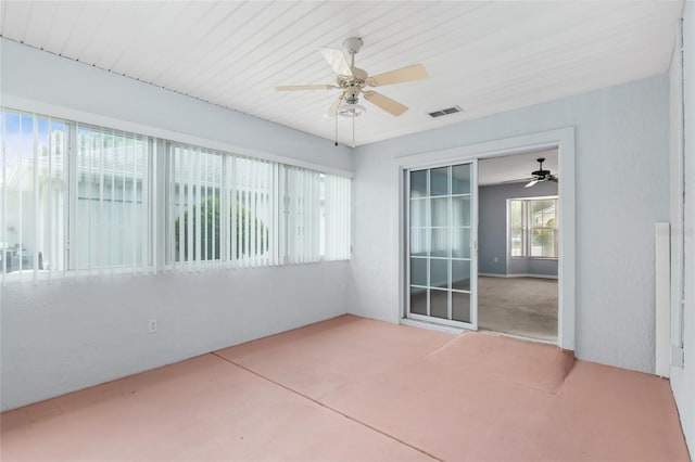 unfurnished sunroom with ceiling fan