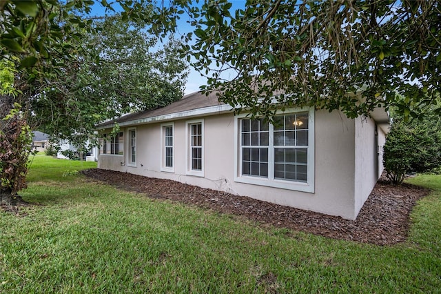 view of home's exterior with a yard