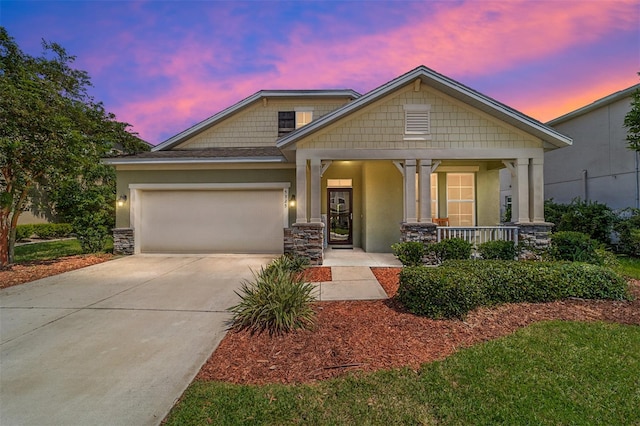 view of front of property featuring a garage and covered porch