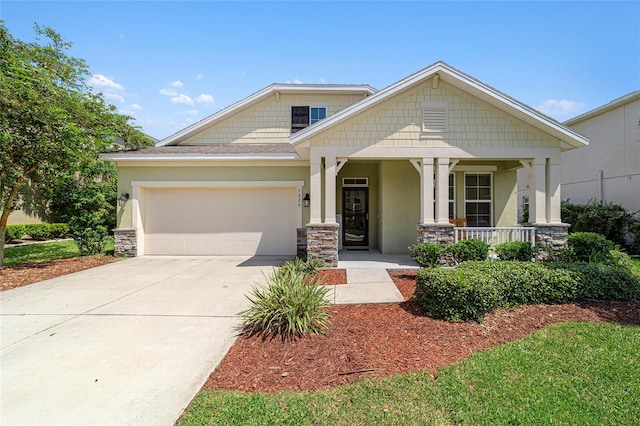 craftsman inspired home featuring a garage and covered porch