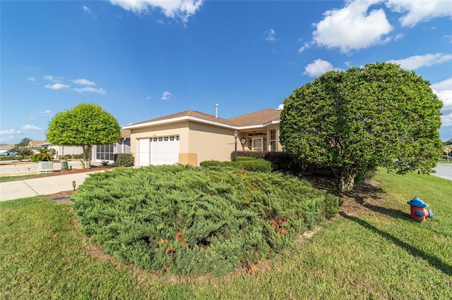 view of front facade featuring a garage and a front lawn