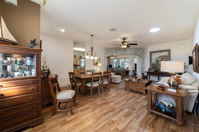 living room featuring light hardwood / wood-style floors and ceiling fan