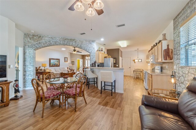 dining space featuring ceiling fan and light wood-type flooring