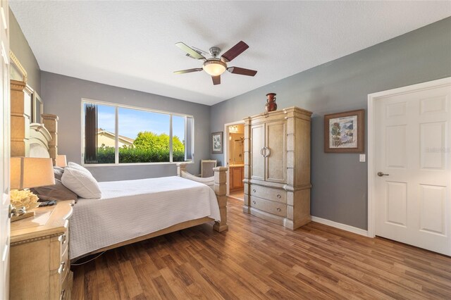 bedroom with ceiling fan and hardwood / wood-style floors