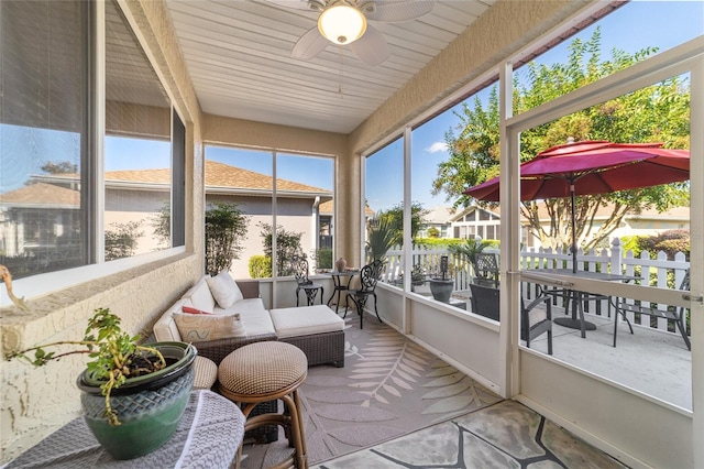 sunroom / solarium with ceiling fan and wood ceiling