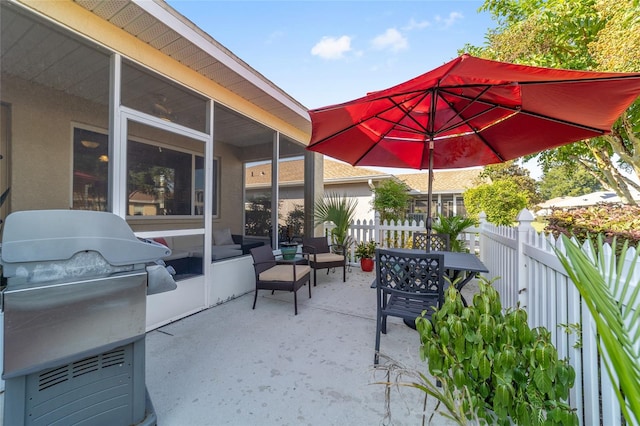 view of patio featuring a sunroom, an outdoor hangout area, area for grilling, and a grill