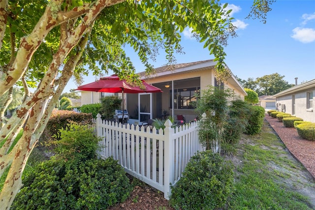 back of property with a sunroom