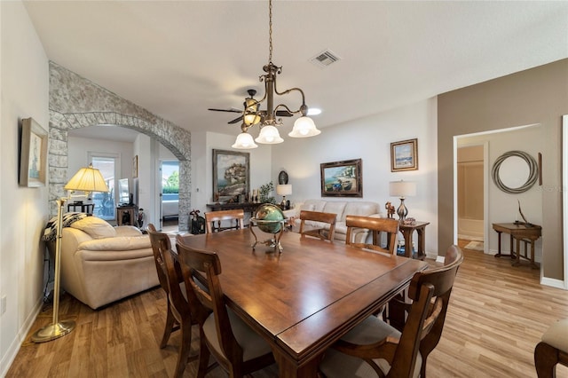 dining space featuring an inviting chandelier and light hardwood / wood-style floors