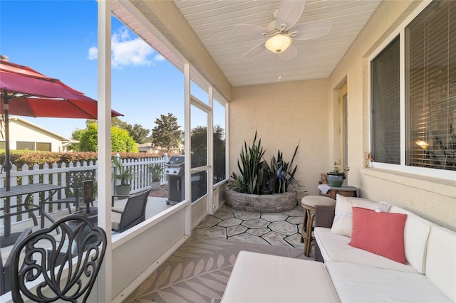 sunroom / solarium featuring ceiling fan