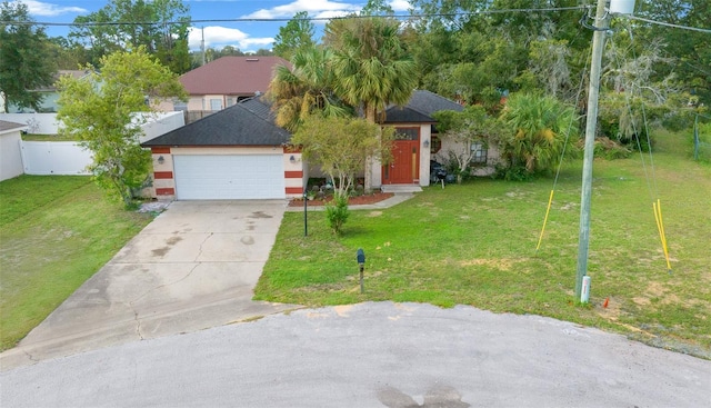 view of front of home featuring a front yard and a garage