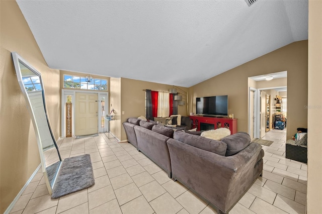 tiled living room with a textured ceiling and vaulted ceiling