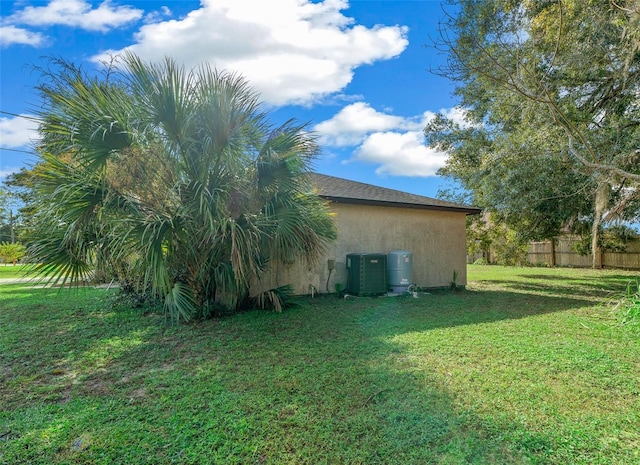 view of home's exterior featuring a yard and central AC