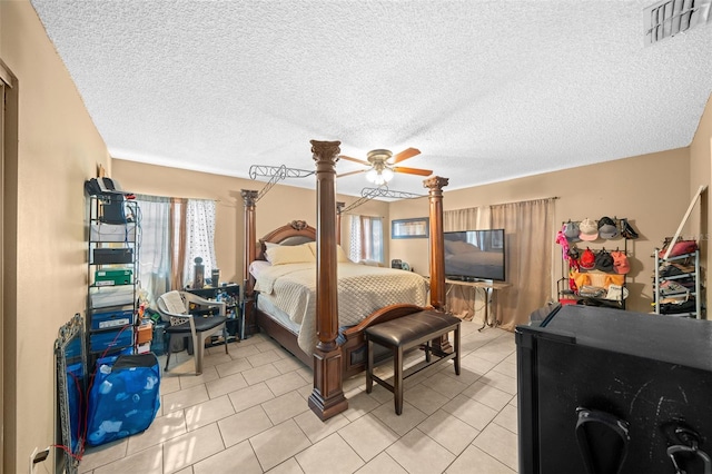 bedroom featuring multiple windows, a textured ceiling, and ceiling fan