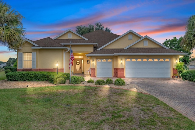 view of front of home featuring a lawn and a garage