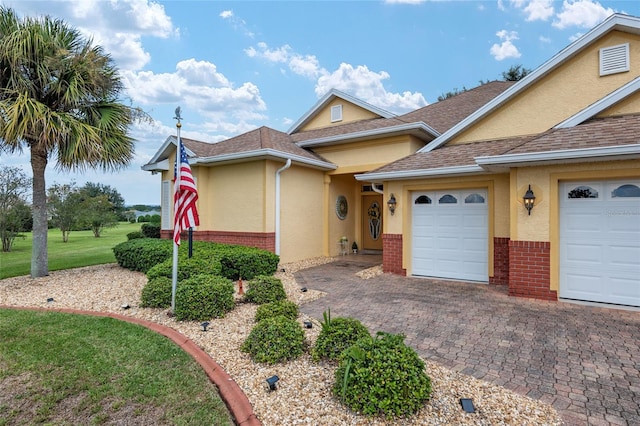 view of front of house with a garage and a front yard